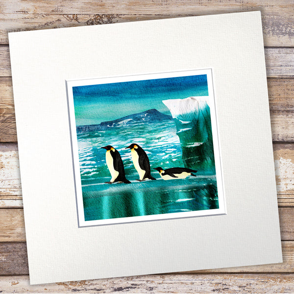 Mounted giclée print of emperor penguins on sea ice with a glacier by Barbara Jane Art & Design. 