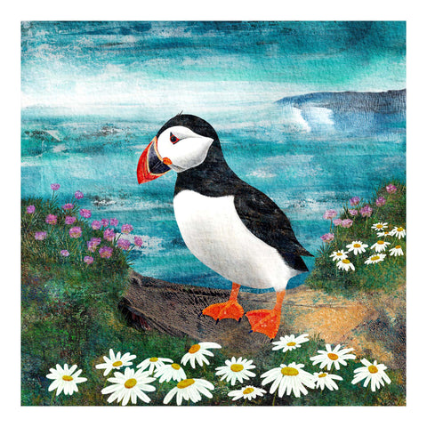 Puffin Art Print featuring a handsome among flowers on the coast with the sea behind.  Perfect gift for bird lovers. Giclée art print by Barbara Jane Art & Design.  barbarajanedesigns.co.uk