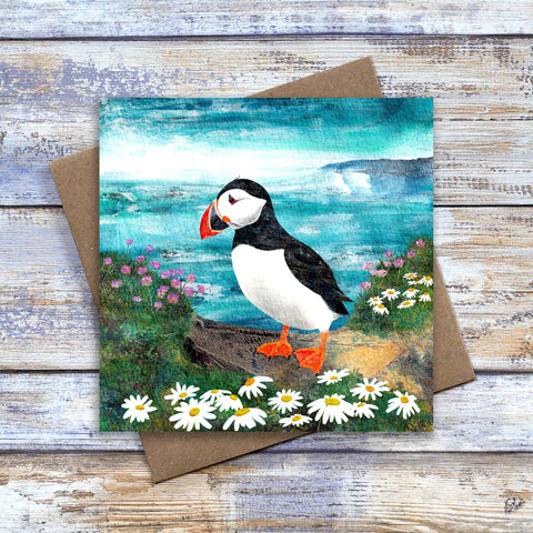 Puffin Greetings Card / Birthday Card / Thank-you card / Thinking-of-you Card.  Handsome puffin on cliff among coastal flowers in front of the blue ocean.  By Barbara Jane Art & Design. 