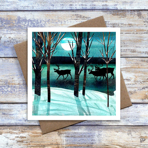 Reindeer greetings card. Three reindeer on  a frozen river silhouetted by moonlight. Perfect birthday or Christmas card for an actic lover.  Artwork by Barbara Jane Art & Design. 